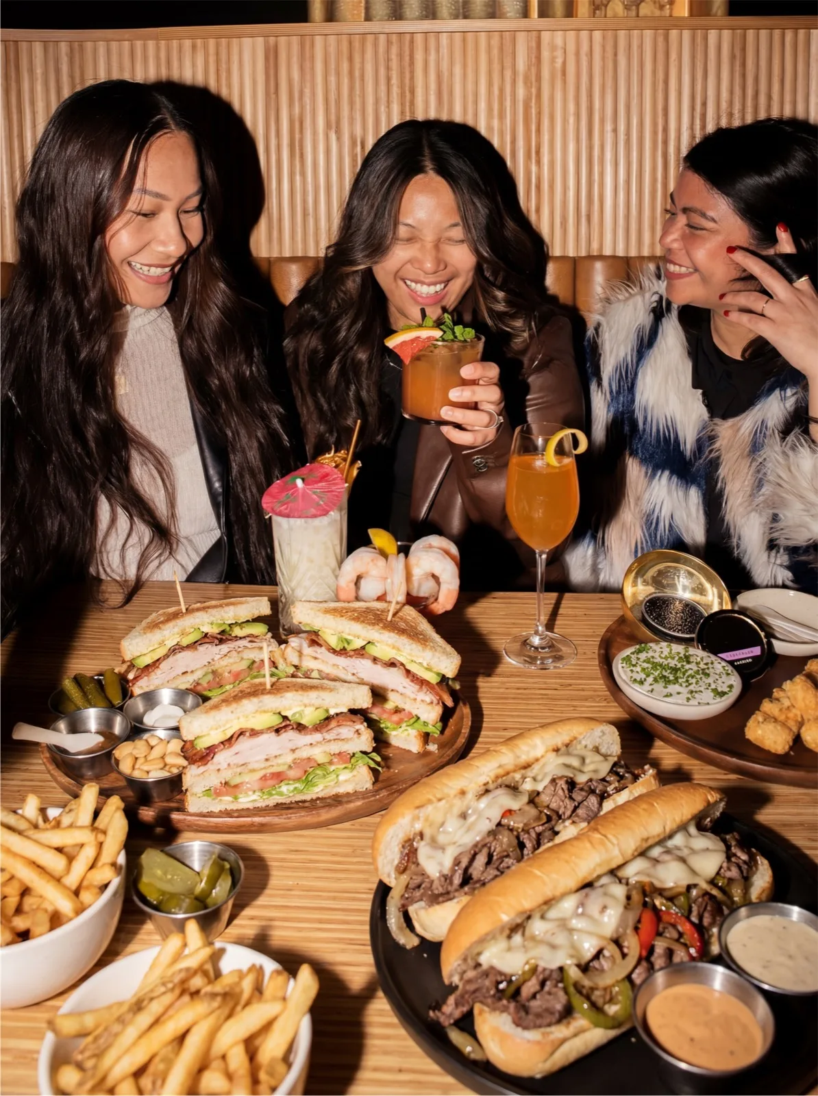 Friends sharing food and drinks at Fefis